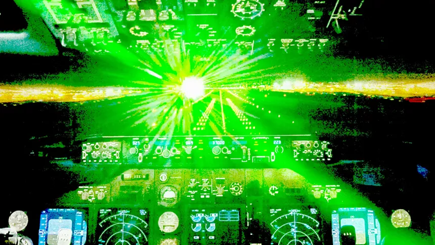 a green light blinds an airplane cockpit