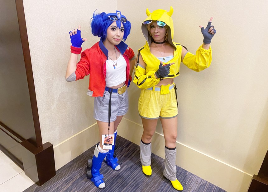 Two girls dressed in colorful outfits.