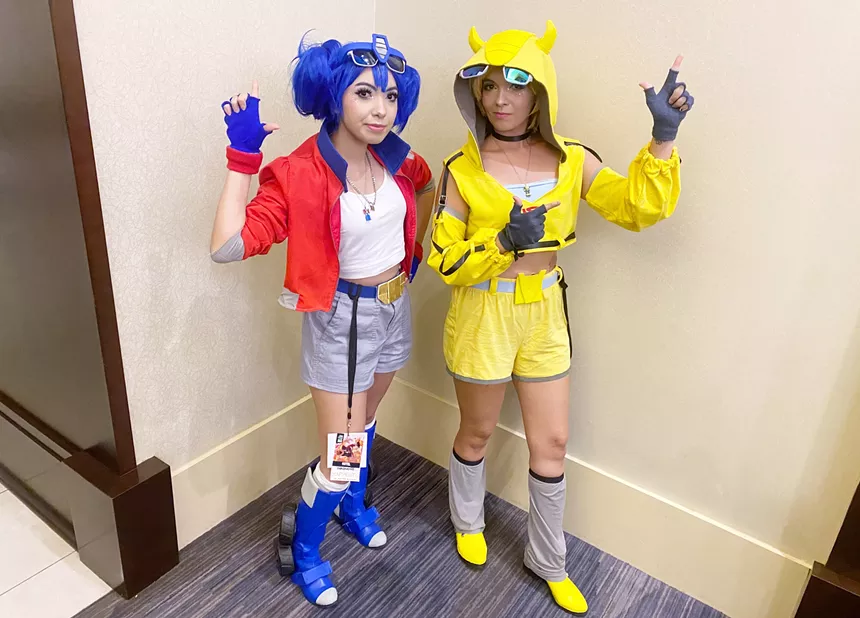 Two girls dressed in colorful outfits.