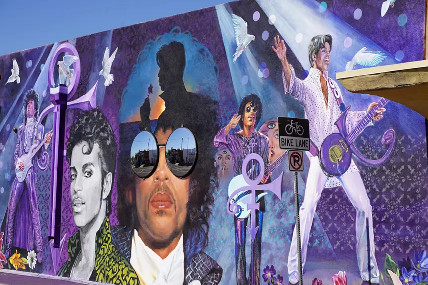 A large colorful mural featuring the musician Prince.