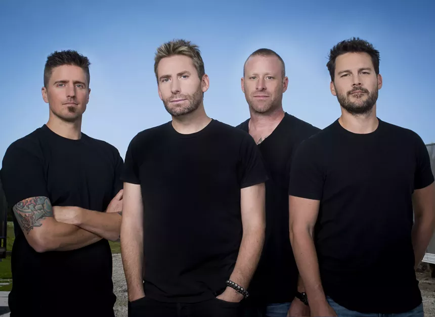 Four men in black t-shirts.