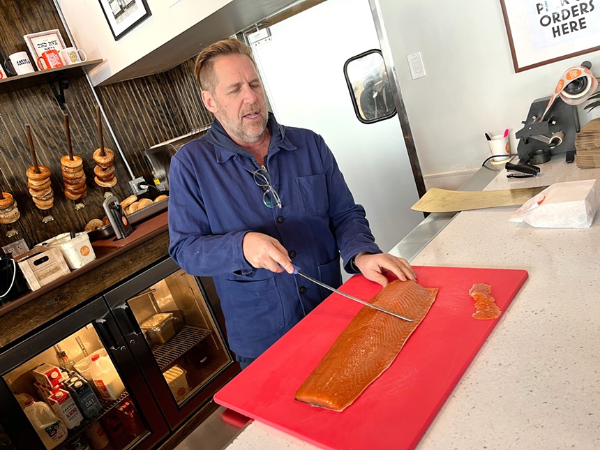 Rick Phillips slices salmon at pop-up deli Little Pickle.