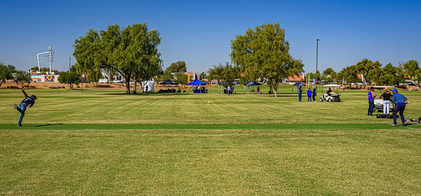 a man bowls a cricket ball to a batter