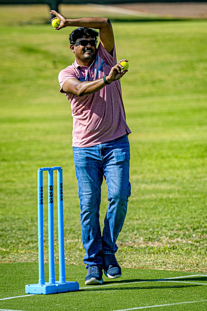 a man readies to bowl a cricket ball