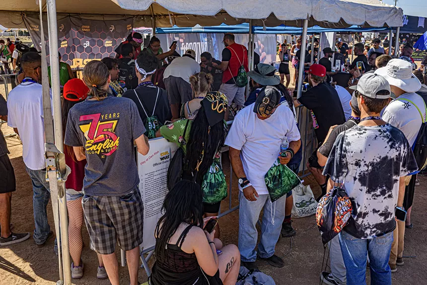 people gather outside a tent