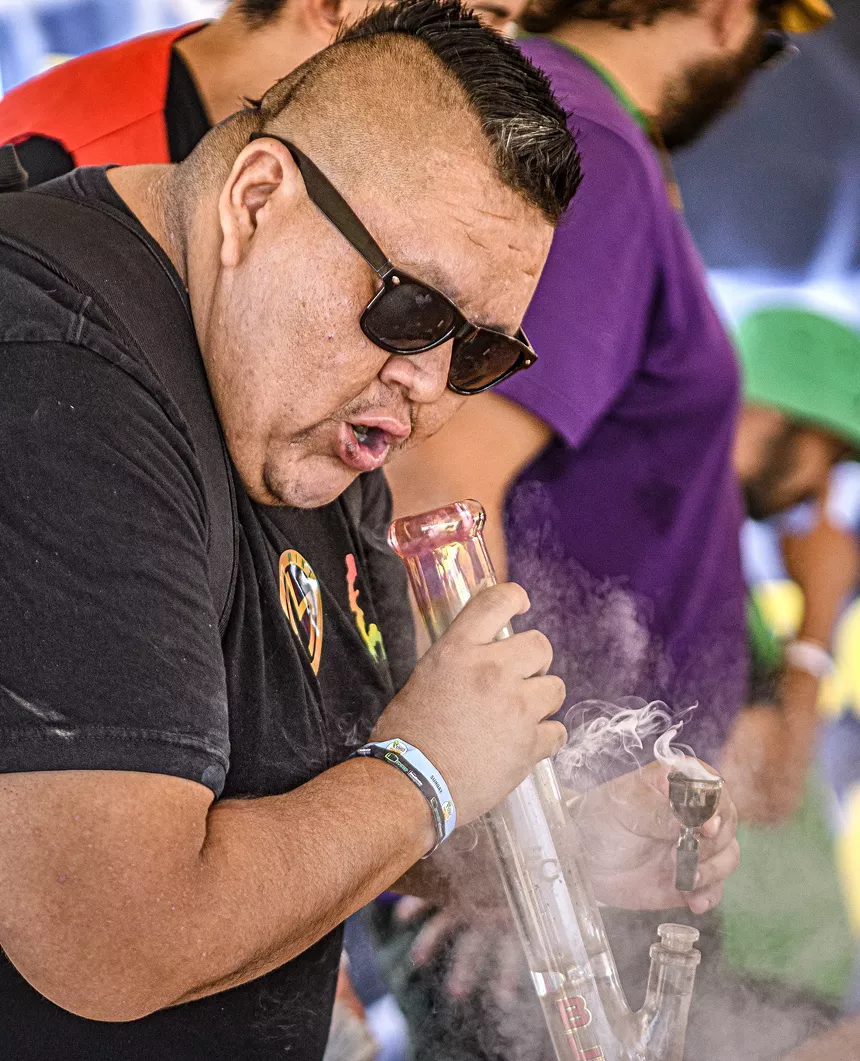 a man smokes from a bong