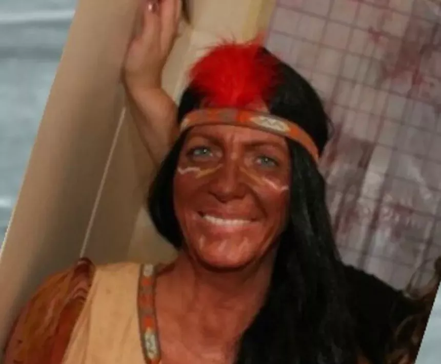 a white woman in redface dressed like Native American stereotype