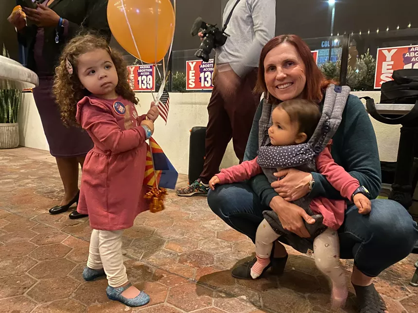 a woman and two young children