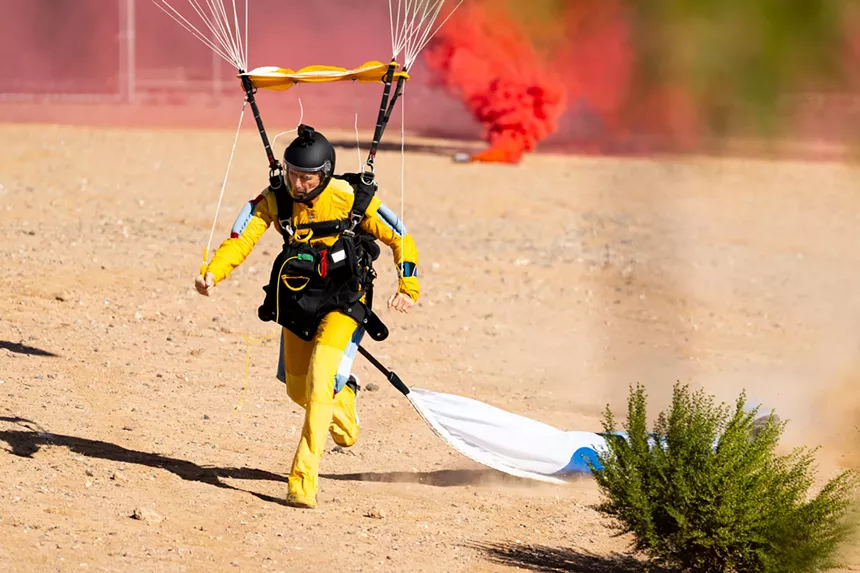 a skydiver lands on the ground