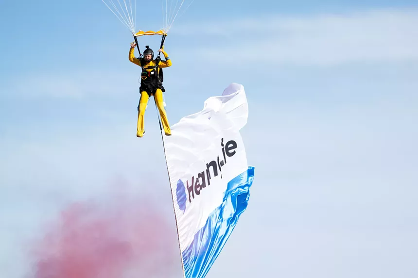 a skydiver comes in for a landing