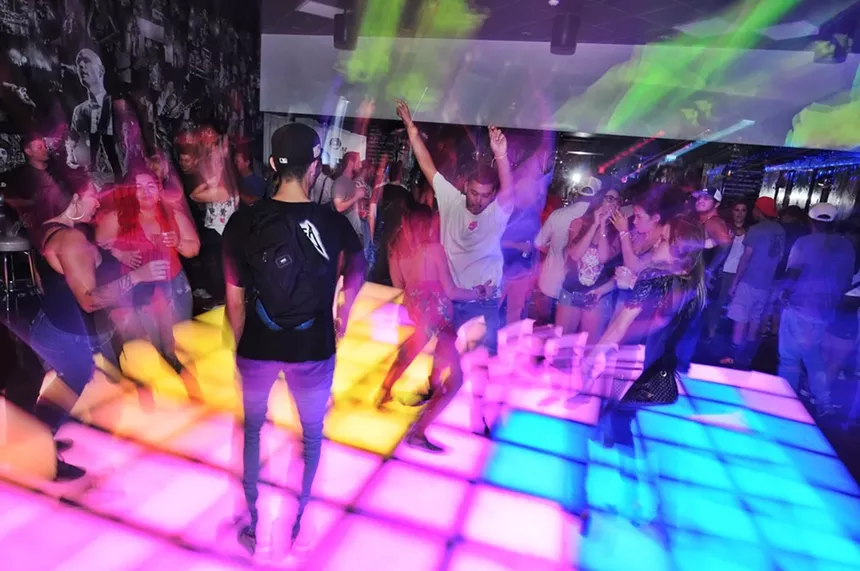 People on a light-up dance floor.