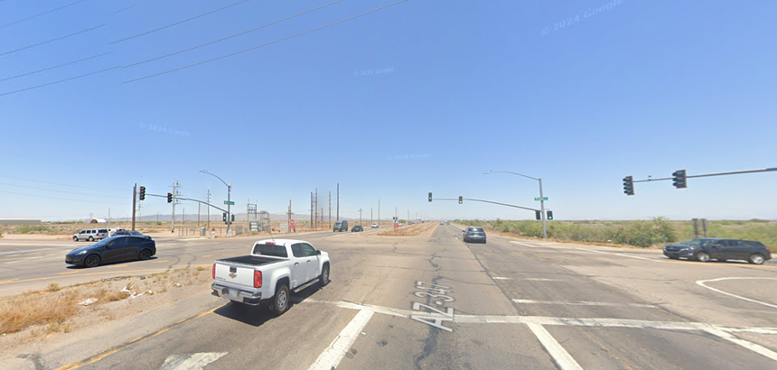 cars going through a rural intersection