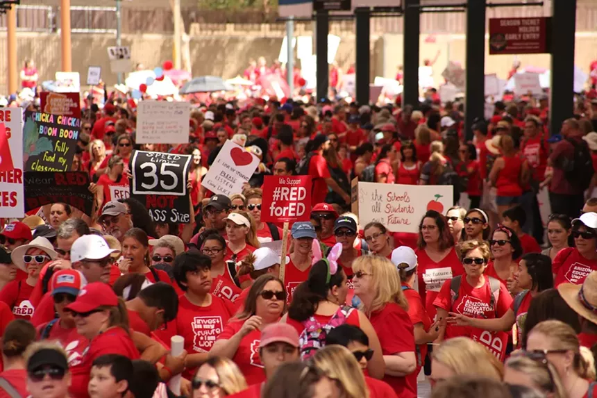 teachers protest while wearing red