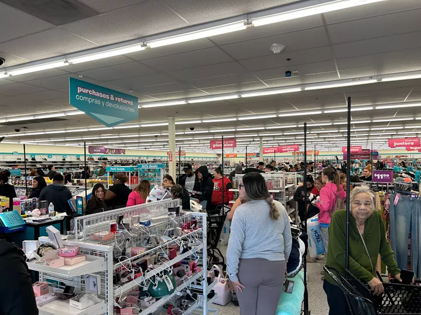 people fill the aisles inside a store