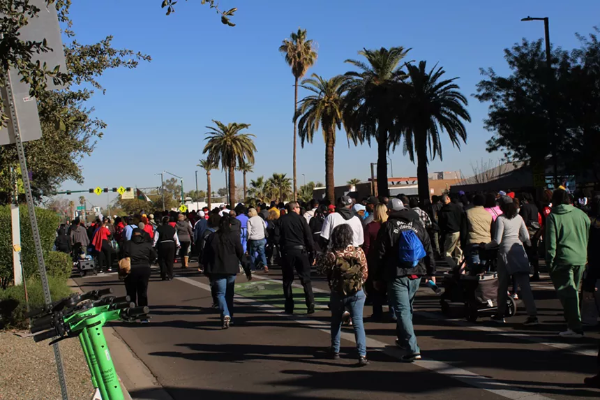 Marchers walk through streets in downtown Phoenix to celebrate Martin Luther King Jr. Day