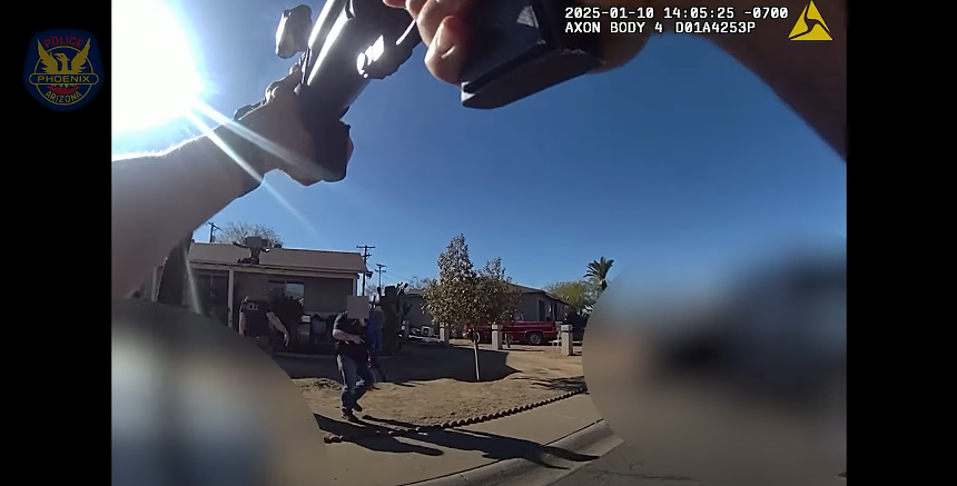 body-cam footage of a man firing a less-lethal weapon at a man on a roof