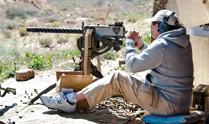A man shoots an M1919 .30 belt-fed machine gun at an Arizona gun range.