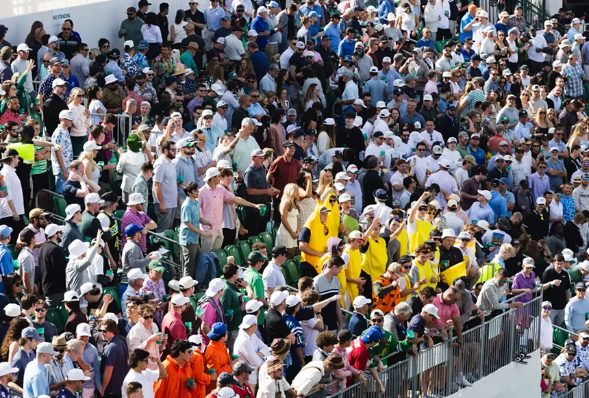 A crowd at a golf tournament.