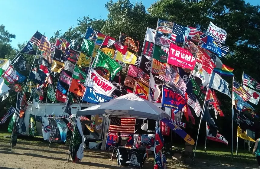 a stand with dozens of flags waving on poles