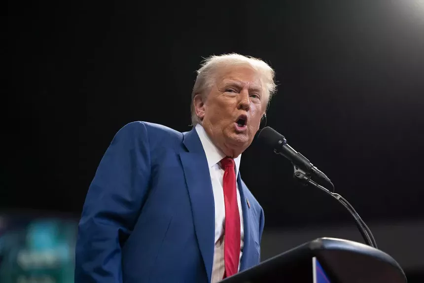 Donald Trump speaking into a microphone