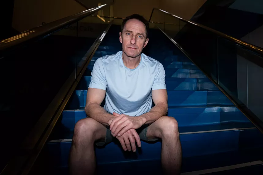 a man sits on a stairwell