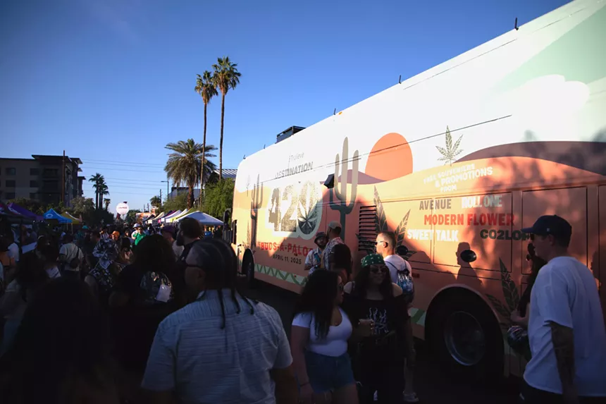people walk by a bus that says "Destination: 420"