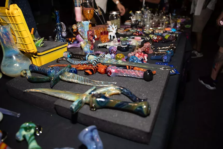 a table display of bongs and pipes