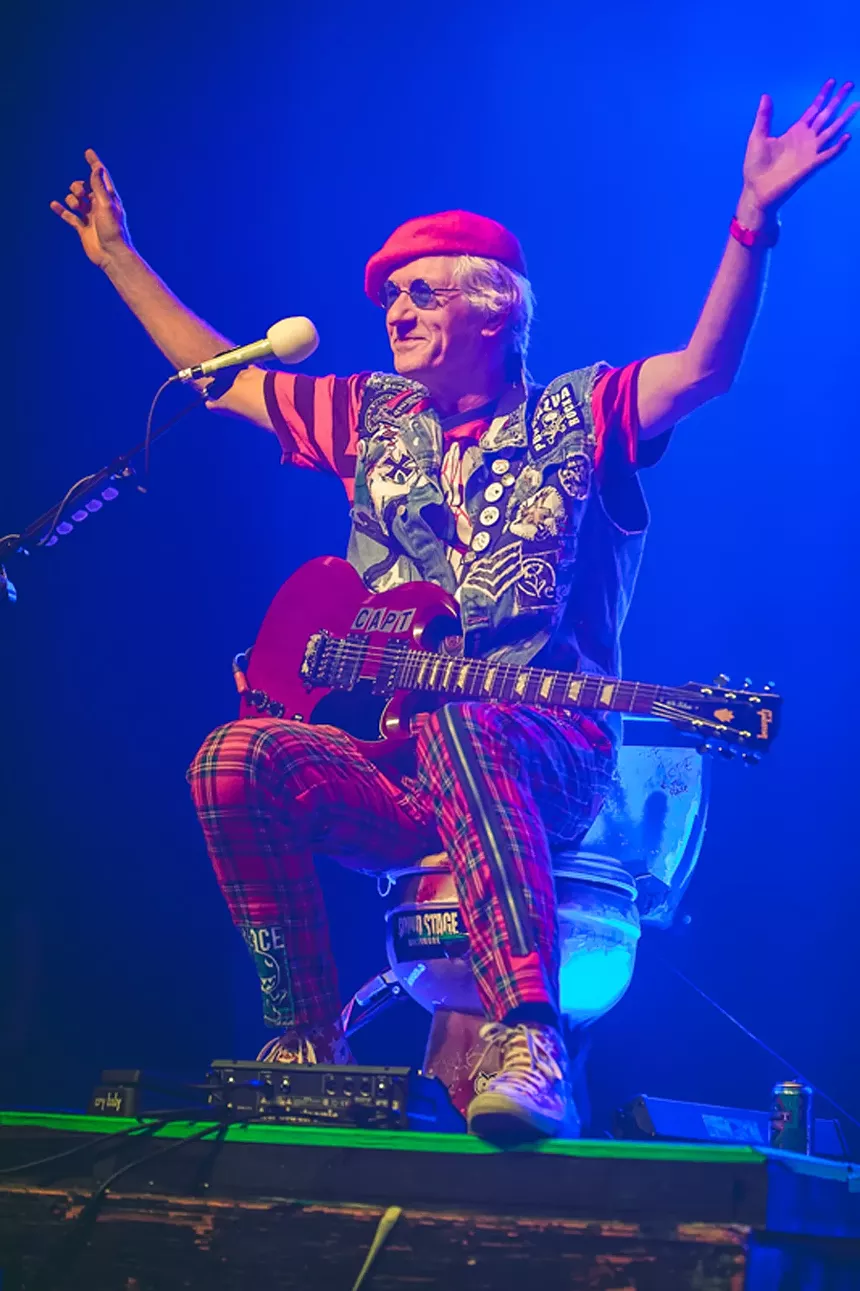Musician performs on toilet throne.