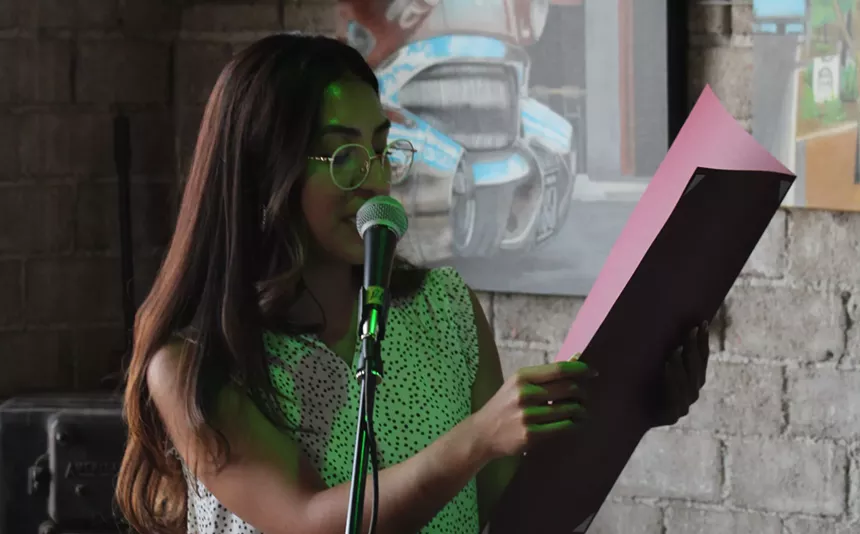 a person reads at a microphone