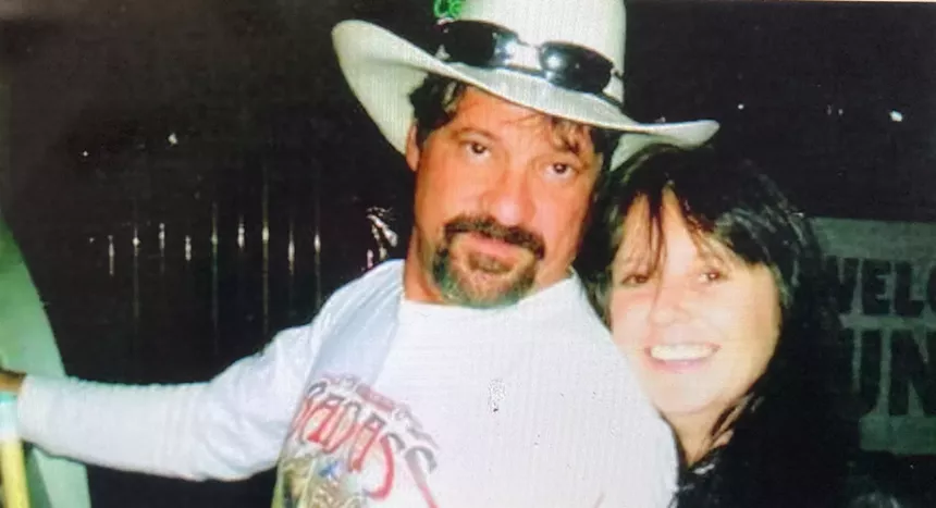 a man in a cowboy hat smiles next to a woman