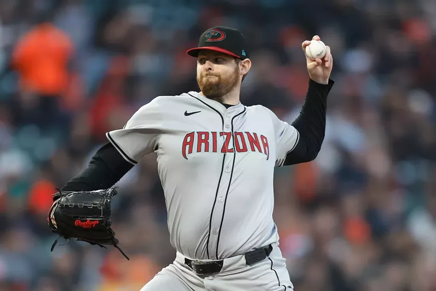 A left-handed pitcher throwing a baseball.