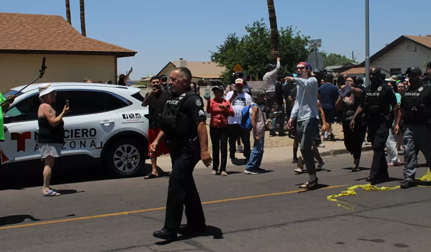 a police officer walks away from protesters
