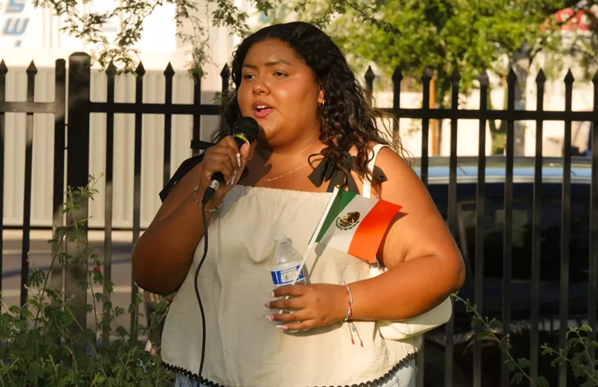 a woman speaks into a microphone