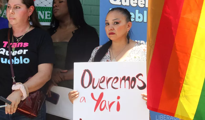 a woman holding a sign at a protest