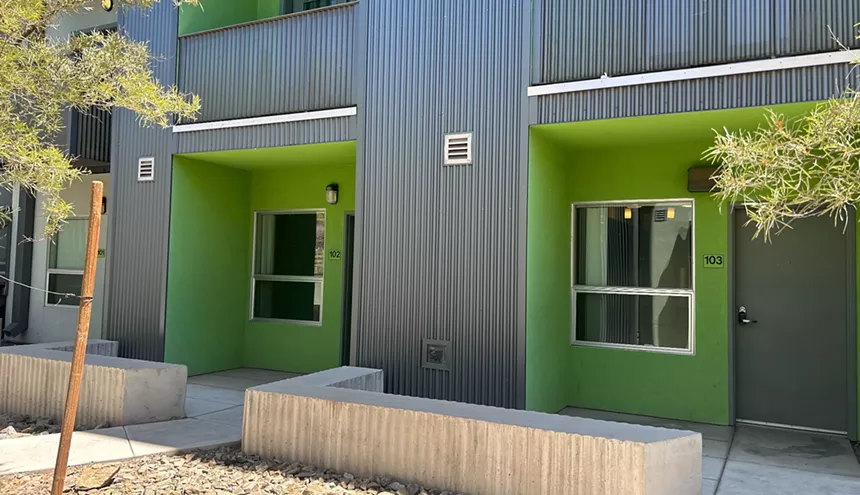 green housing units in a gray building