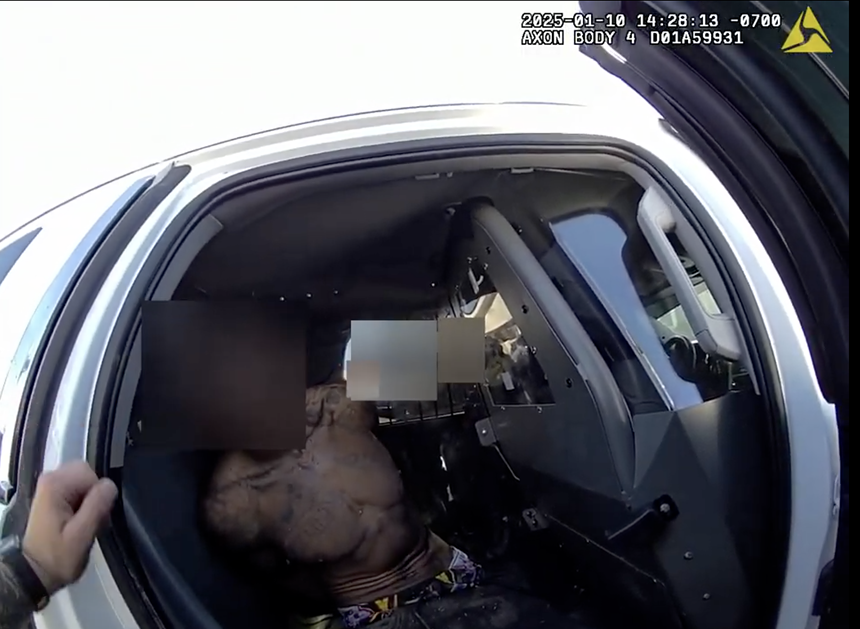 A Phoenix police officer attends to Turrell Clay after he was shot with less-lethal launchers in the Phoenix neighborhood of Maryvale on Jan. 10, 2025.