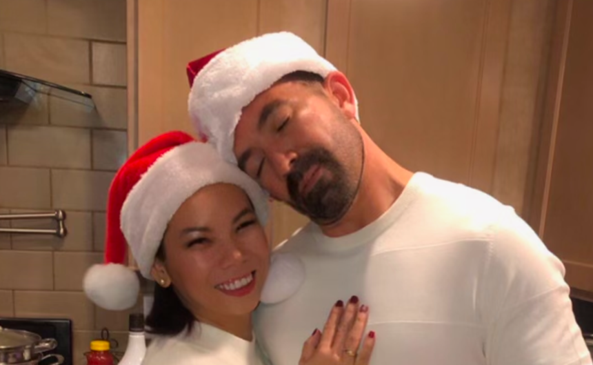 a man and woman take an affectionate picture in santa hats