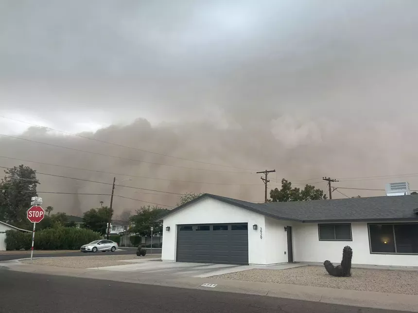 a haboob blowing behind a house