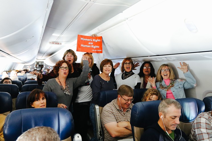 A group of women from Phoenix gathered for a photo mid-flight on Thursday, January 19. - EVIE CARPENTER