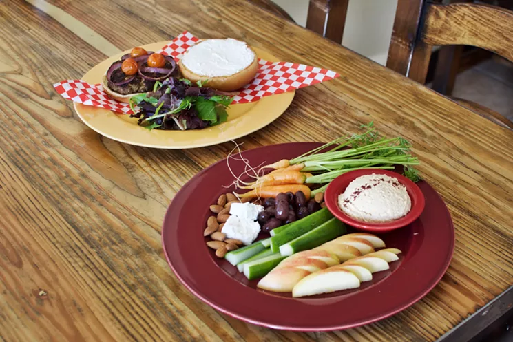 Above: The Persian Burger has a classic koobideh meat patty. Below: Fresh produce grown at St. Vincent de Paul is featured on the hummus plate, as well as house-made olives and Bulgarian feta. - STEPHANIE FUNK