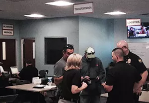 A group of emergency personnel gather for an update inside the Phoenix Emergency Operations Center on Friday. They are some of the 150 people working here to keep NCAA Final Four weekend safe. - SEAN HOLSTEGE