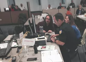 Teams inside the Phoenix Emergency Operations Center coordinate plans to make the Final Four weekend safe on Friday, March 31, 2017. - SEAN HOLSTEGE
