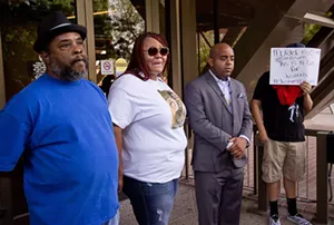 Fred Franklin, Sarah Coleman, Jarrett Maupin, and an anonymous man delivered an emotional plea for public support at Tempe City Hall on Thursday following the decision to clear the officer who shot Dalvin Hollins, Coleman and Franklin's son. - TOM CARLSON