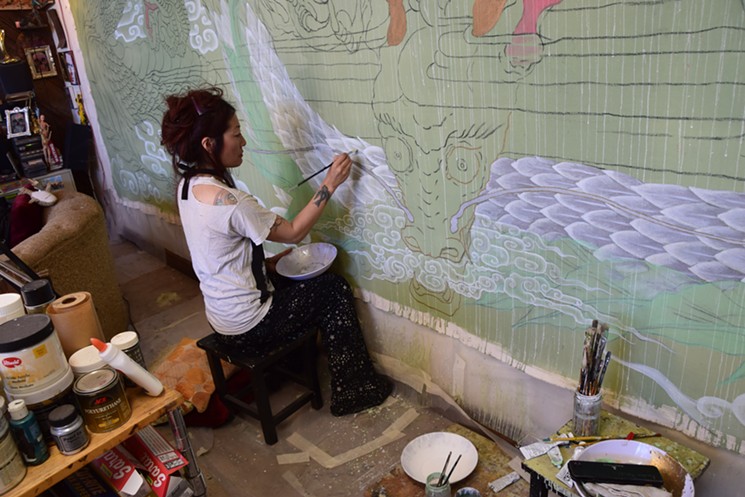 Artist Yuko Yabuki working on a large-scale painting in her Tempe studio. - LYNN TRIMBLE