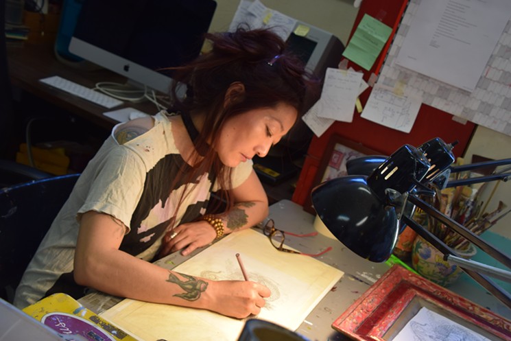 Yuko Yabuki works on a dragon drawing in her Tempe studio. - LYNN TRIMBLE