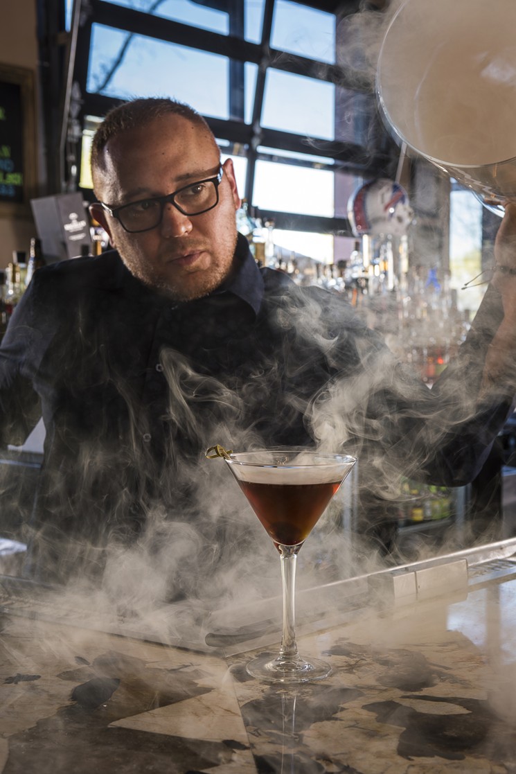 Chris Cuestas of Torch Cigar Bar unveils his smoked Manhattan. - JEFF NOBLE