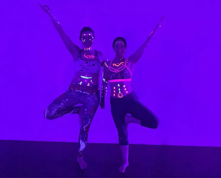 During Floo-id Yoga’s Glow with the Flow sessions, practitioners can wear glow-in-the-dark paint and bracelets while practicing poses. - KARLI HORNER