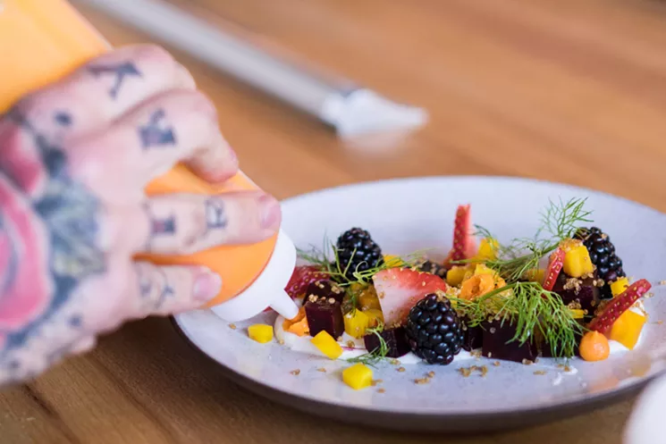 Restaurant Progress' TJ Culp plates up a starter salad of roasted beets with goat cheese, berries, carrots, quinoa, and fennel. - SHELBY MOORE