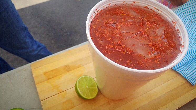A cup of tepache topped with chile seasoning. - PATRICIA ESCARCEGA