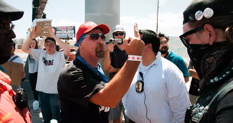 A Trump supporter engages with an anarchist protester during a Trump rally last year. Police will attempt to keep the two sides apart tonight. - ASH PONDERS